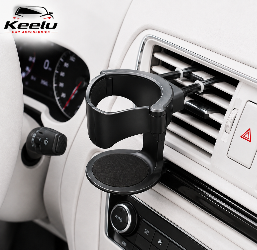 A black car cup holder mount clipped onto a white vehicle air vent, shown installed in a car interior.