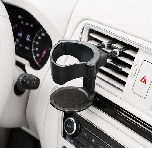 A black car cup holder mount clipped onto the dashboard air vent, shown installed in a white car interior.